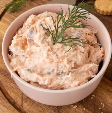 smoked salmon dip in a pink bowl served with fresh dill