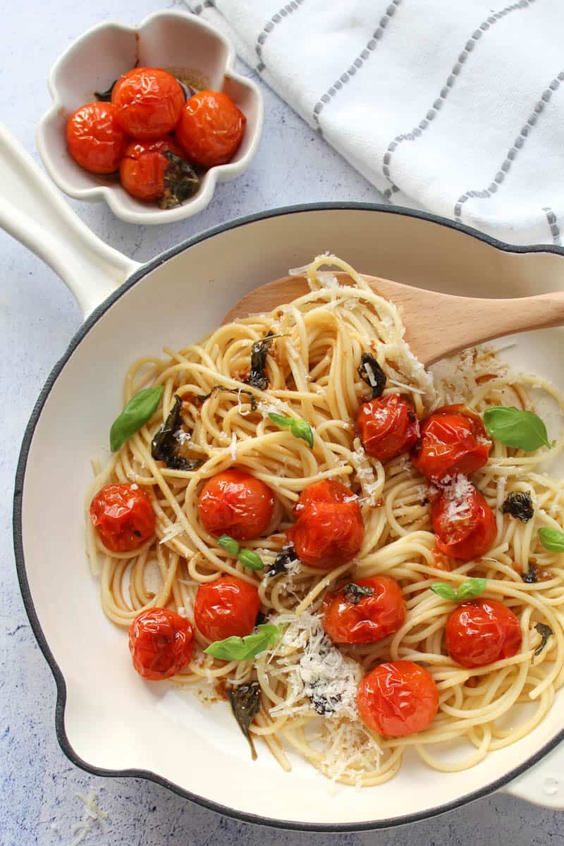 pasta with roasted tomatoes in a white Dutch oven