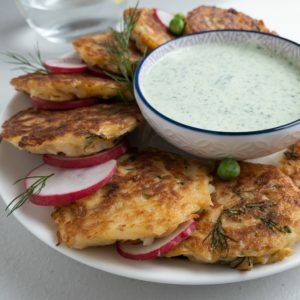 Zucchini And Halloumi Fritters on a round plate