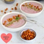 purple cauliflower soup ina bowl with roasted chickpeas and dukkah