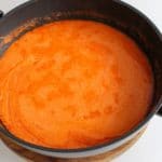 butter chicken tomato sauce in a black frying pan