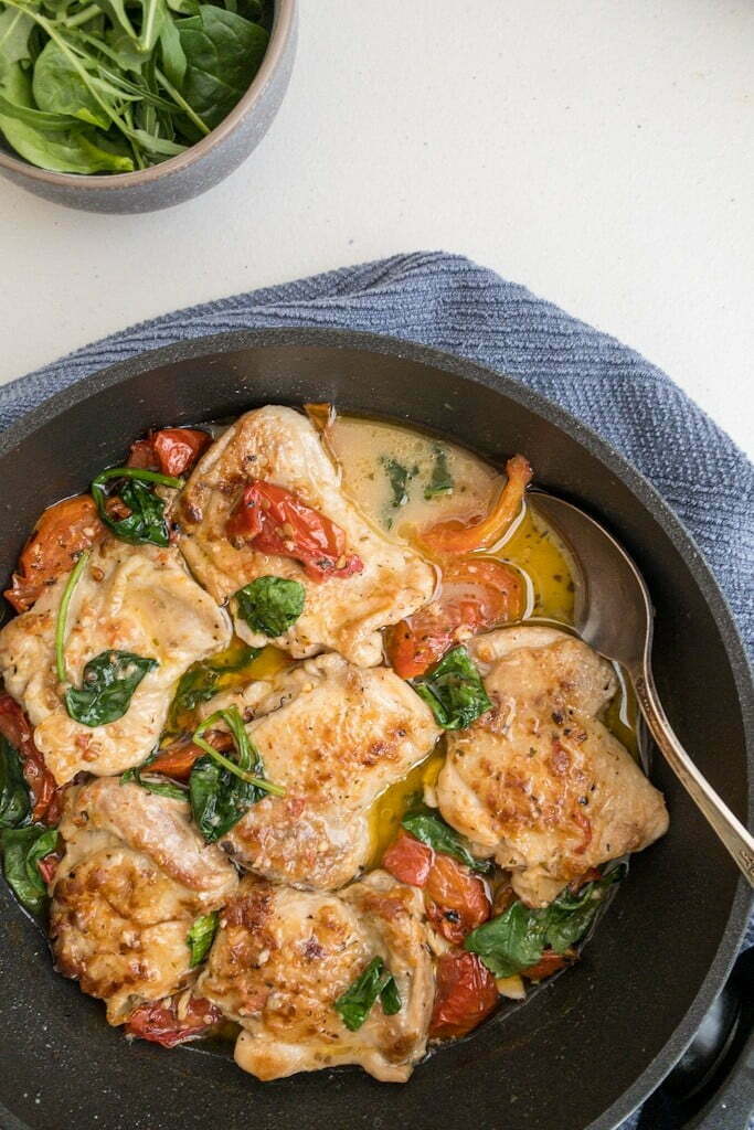Healthy Tuscan Garlic Chicken, Fried chicken thighs with sundried tomatoes in a pan