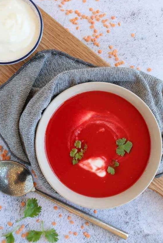 Beetroot soup  in bowl with yogurt  on a side