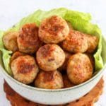 chicken meatballs in a bowl with lettuce