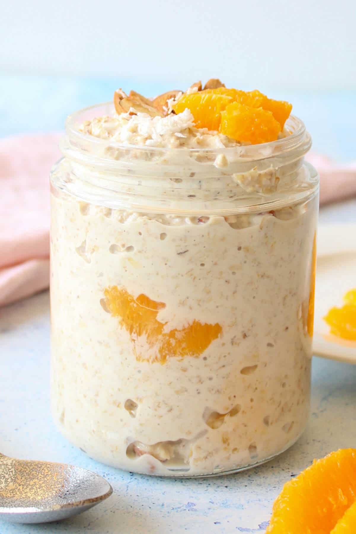 overnight oats with orange pieces in a mason jar