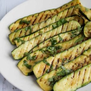 grilled zucchini slices on a plate