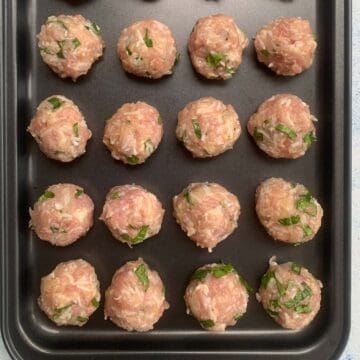 raw meatballs on a tray