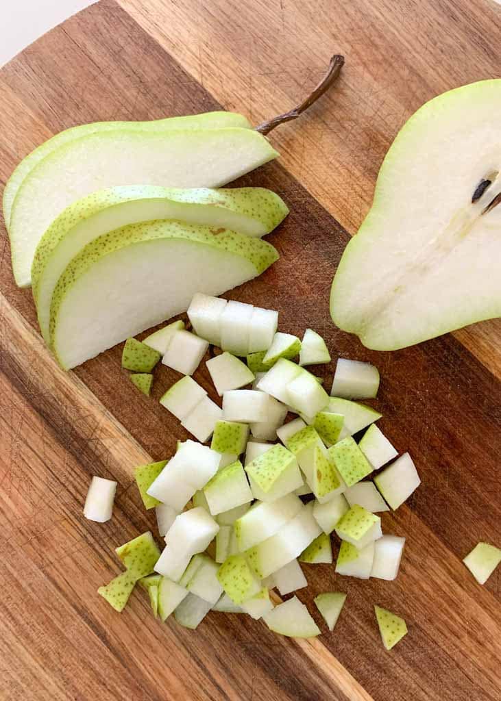 diced and slicedpear on a wooden chopping board 