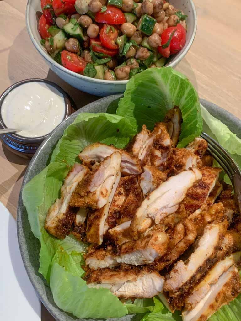 Chicken shawarma cut into strips with cos lettuce and yoghurt