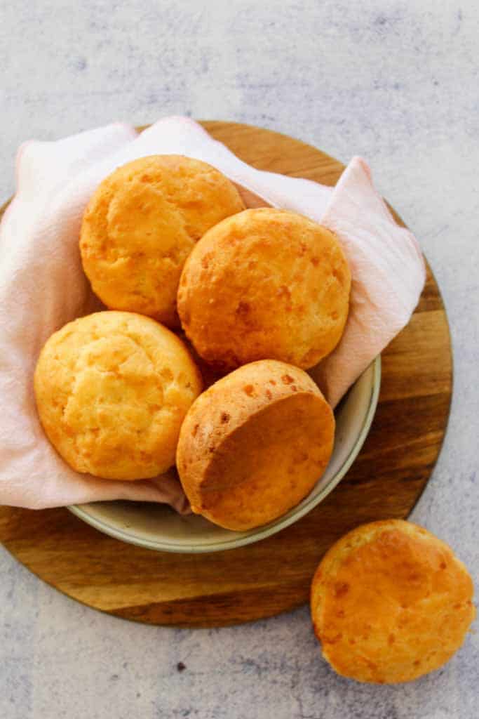 brazilian cheese breads in a bowl  with pink napkin 