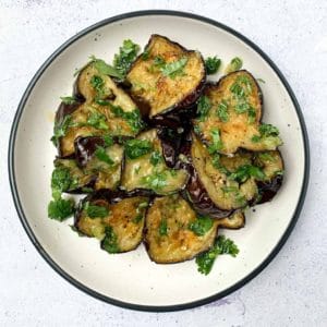 roasted eggplant slices on a round white plate