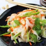rice noodles with fresh carrots, cucmbers and mint on a blue plate