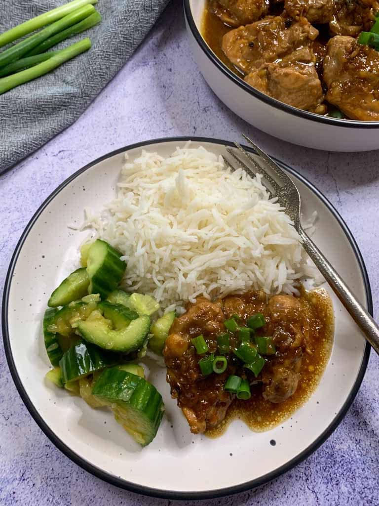chicken with basmati rice and spring onions served to eat