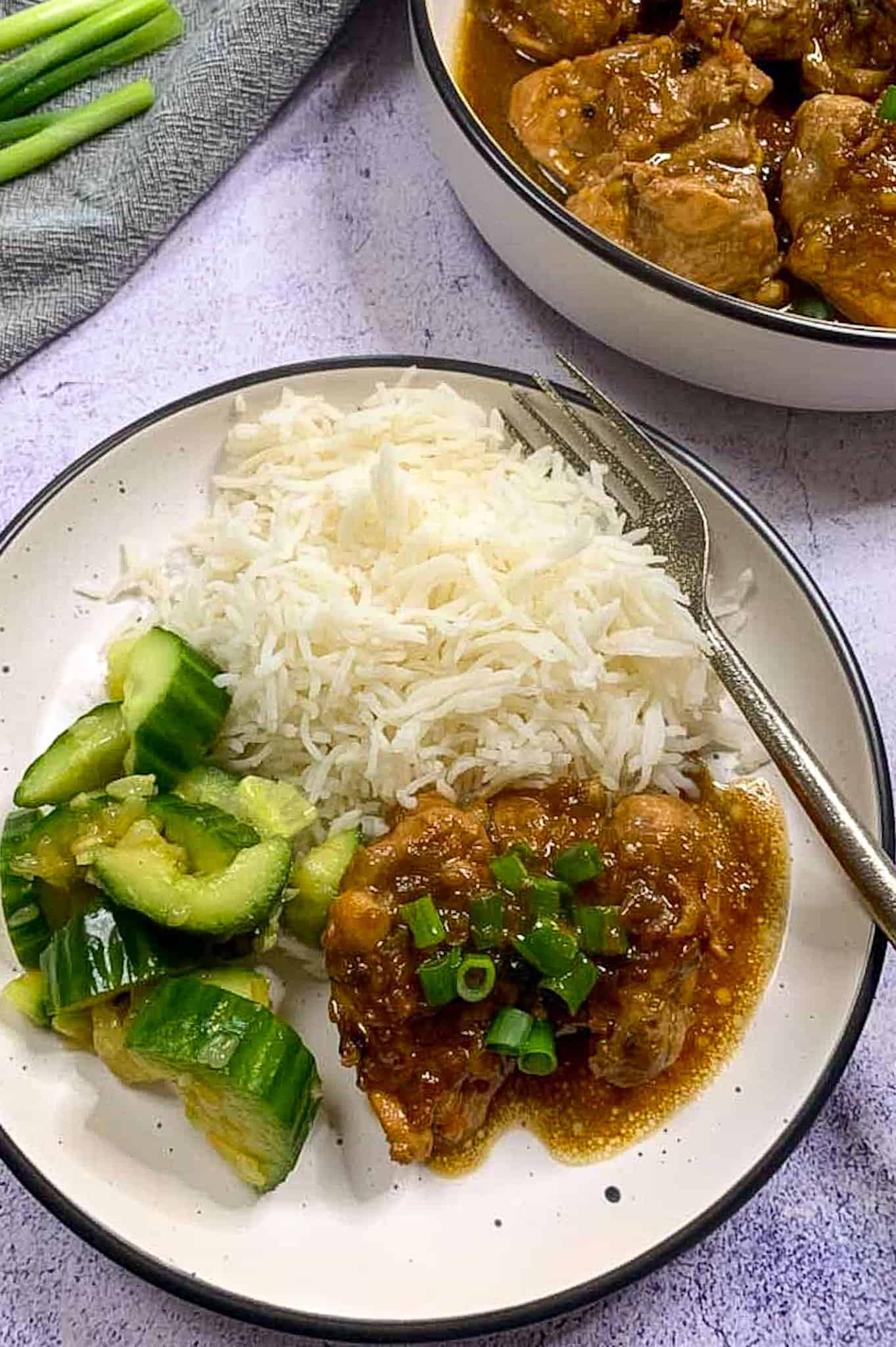 adobo chicken served with basmati rice and smashed cucumbers
