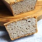 a slice of buckwheat bread on a wooden chopping board.