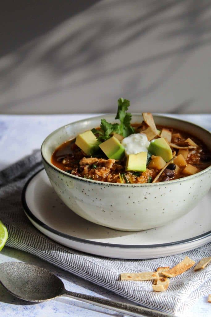 thick soup with diced avocado and shredded chicken