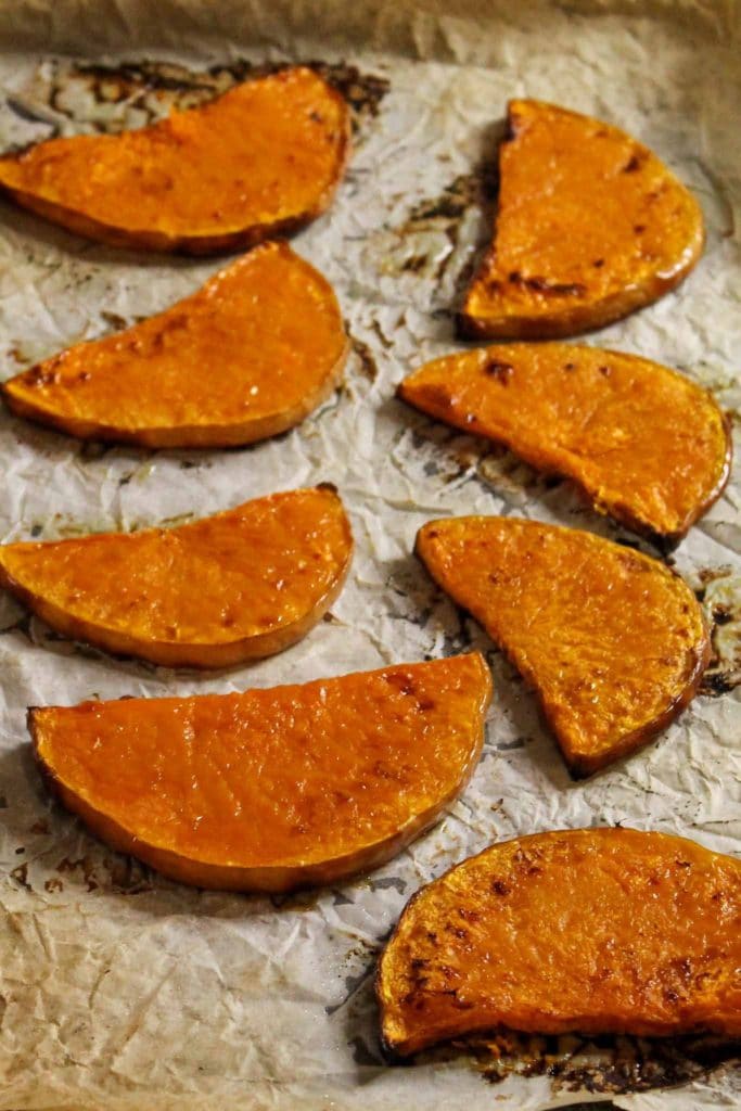 slices of raosed pumpkin on a baking tray