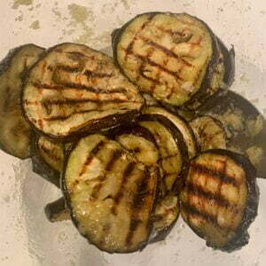 grilled eggplant slices in a glass bowl