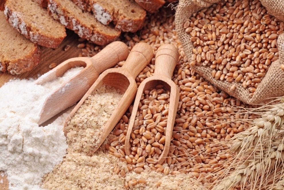 loose wheat cornels with three wooden spoons