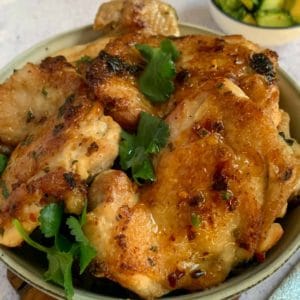 baked lemon and garlic chicken in a grey bowl