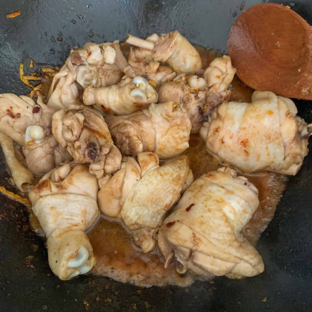 chicken pieces in a wok