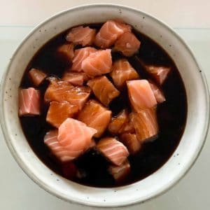 poke bowl, salmon in marinade in a round bowl