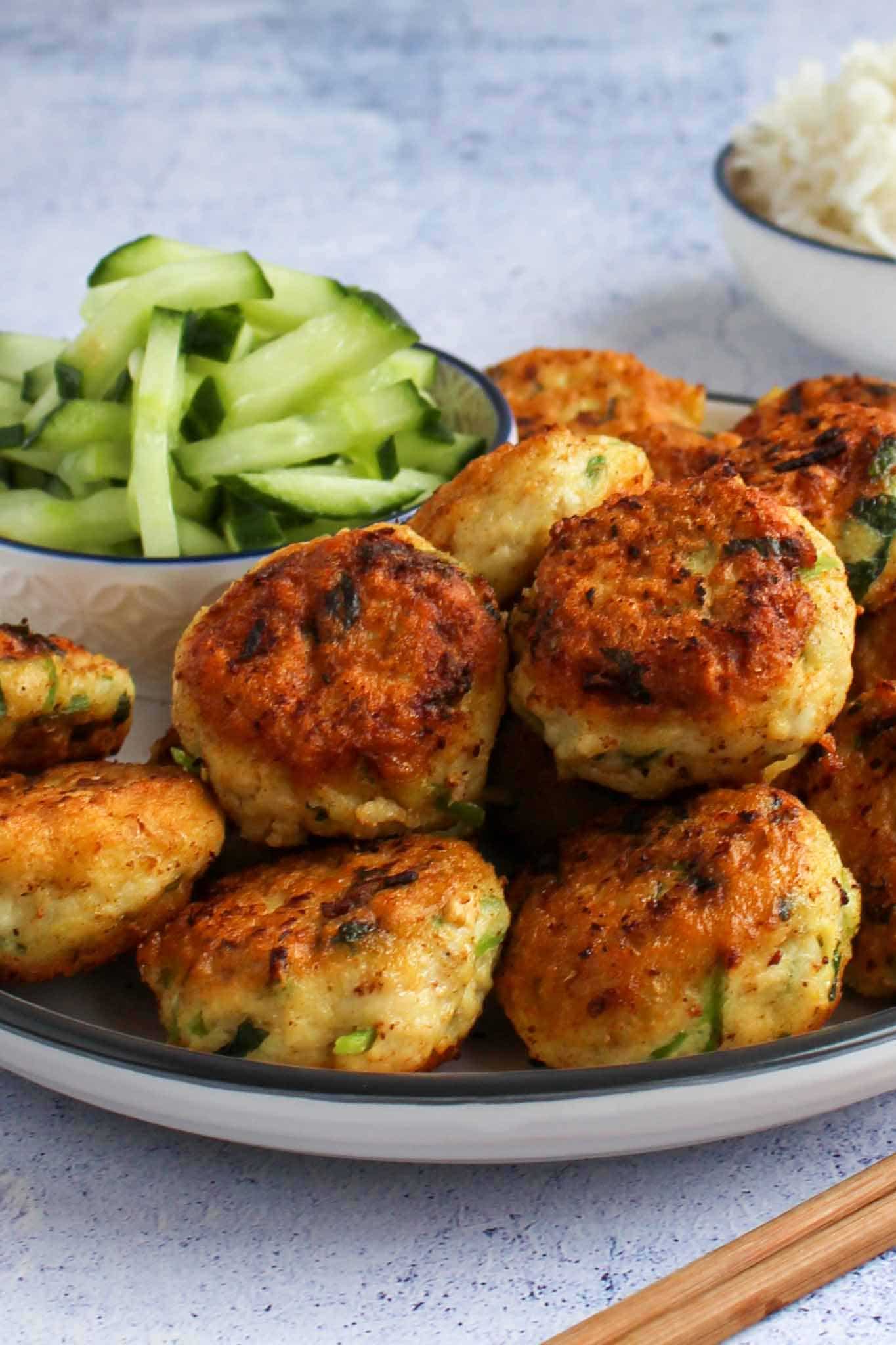 thai fish cakes on a plate with cucumber relish