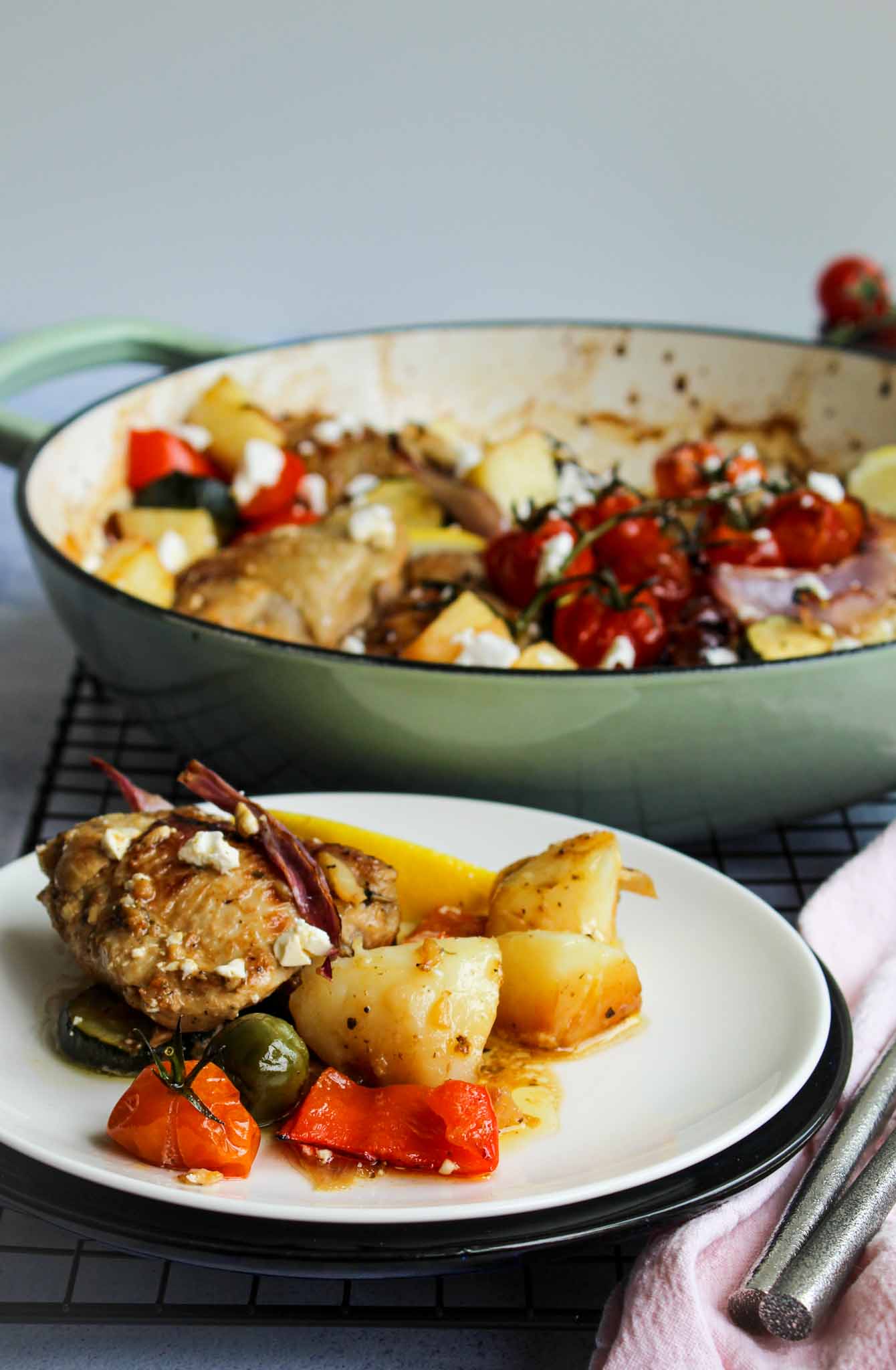 a plate with Greek style roast chicken served with potatoes, , capsicum, fetta and olives