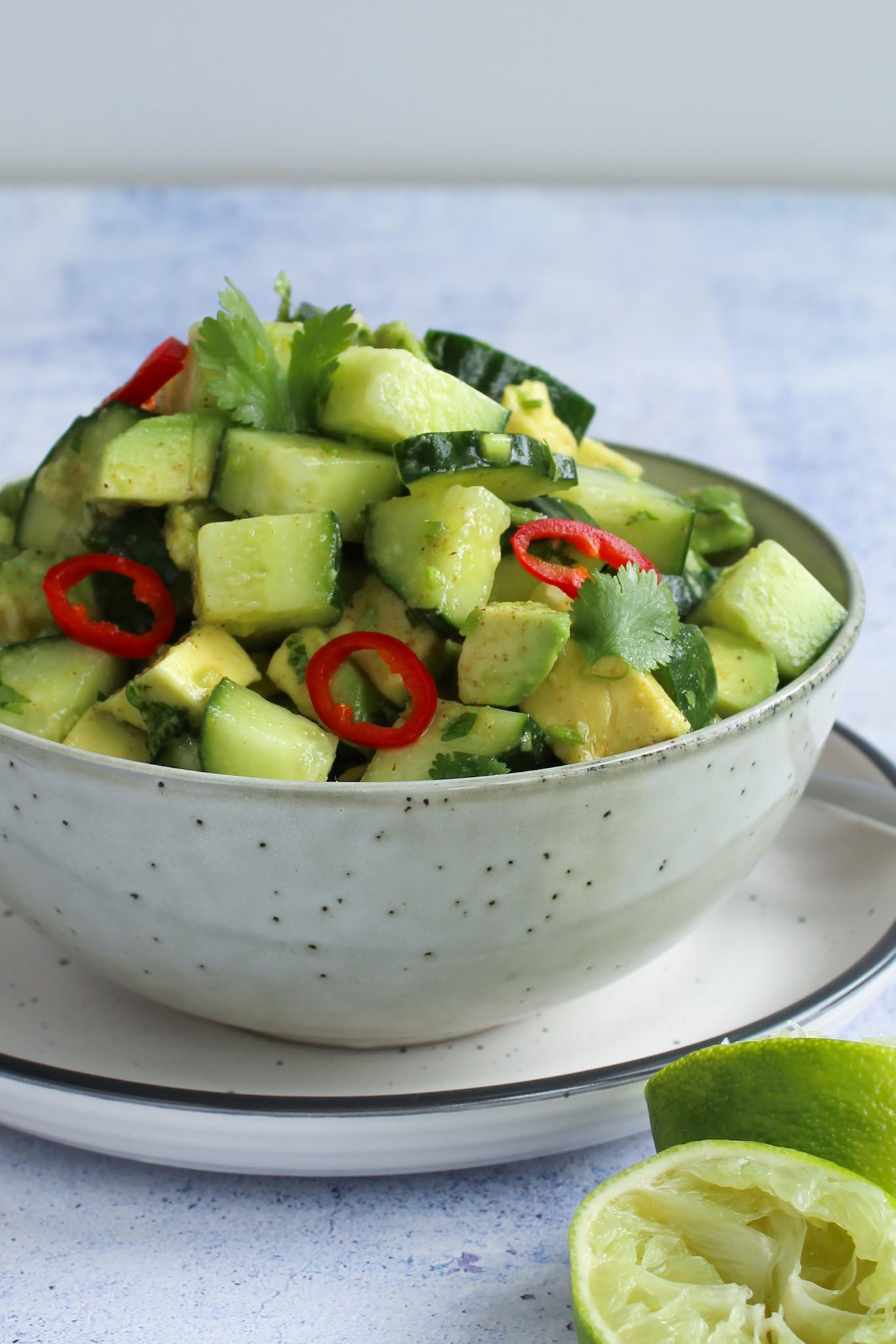 cucumber and avocado salad in a grey salad bowl