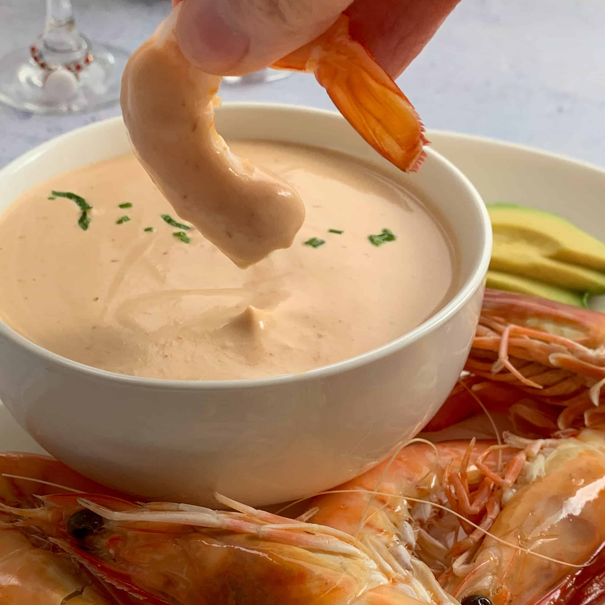 shrimp dipped into seafood sauce
