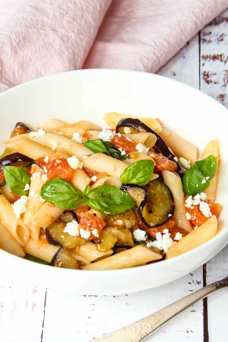 pasta melanzane, eggplant pasta served with fresh tomatoes and basil leaves