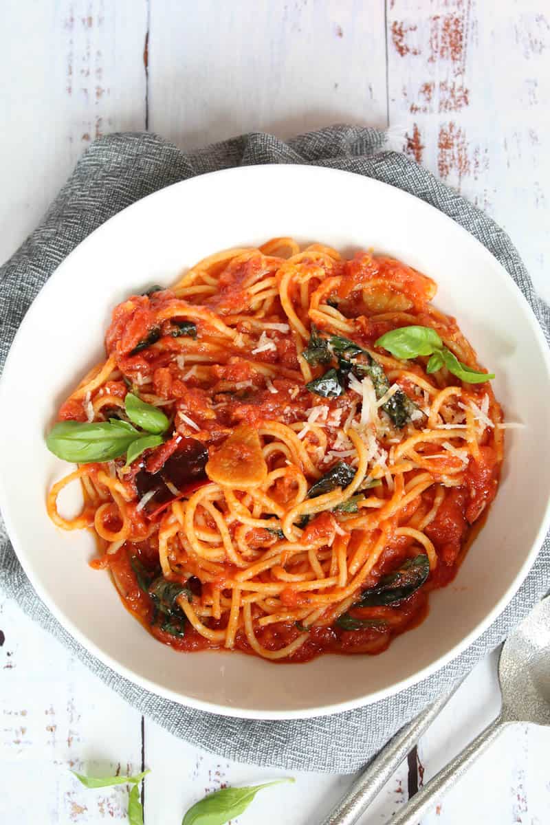 arrabbiata sauce served with spaghetti in a white bowl