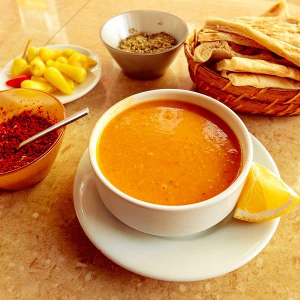 Turkish soup served with flat bread and peppers