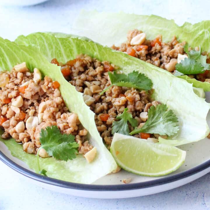 three lettuce wraps filled with chicken mince San choy bau