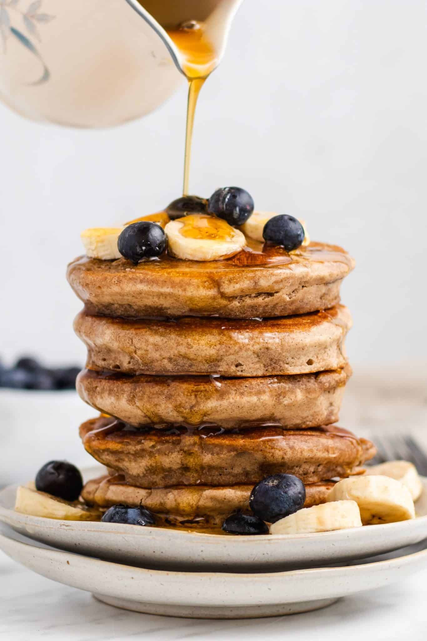 a staple of buckwheat pancakes served with blueberries and hoeny