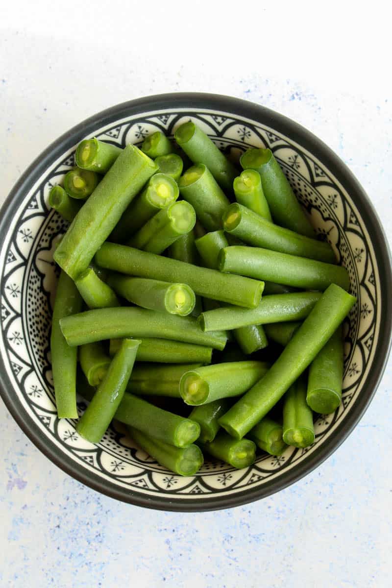 a bowl with green beans cut into sticks