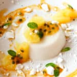 coconut panna cotta served with pineapple, passion fruit and merengue crumbs