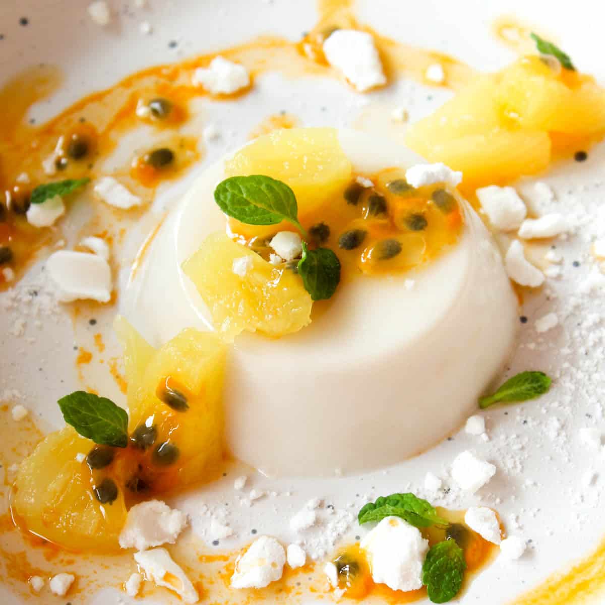coconut panna cotta served with pineapple, passion fruit and merengue crumbs