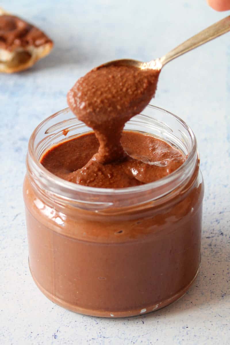 chocolate hazelnut spread in a glass jar with a spoon