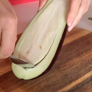 scooping eggplant flesh