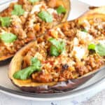 karniyarik Eggplant halves stuffed with ground lamb , served with yogurt and fresh cilantro leaves