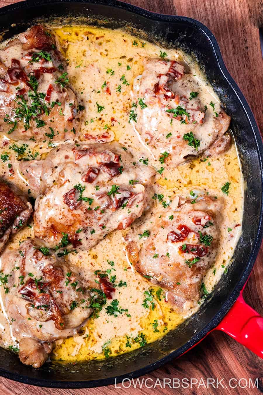 marry me chicken in a white creamy sauce with sun dried tomatoes in a skillet