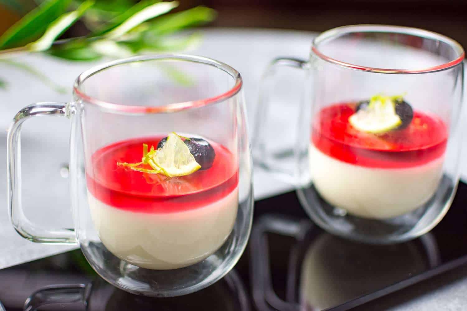 two cups with CHAI PANNA COTTA topped with CRANBERRY JELLY