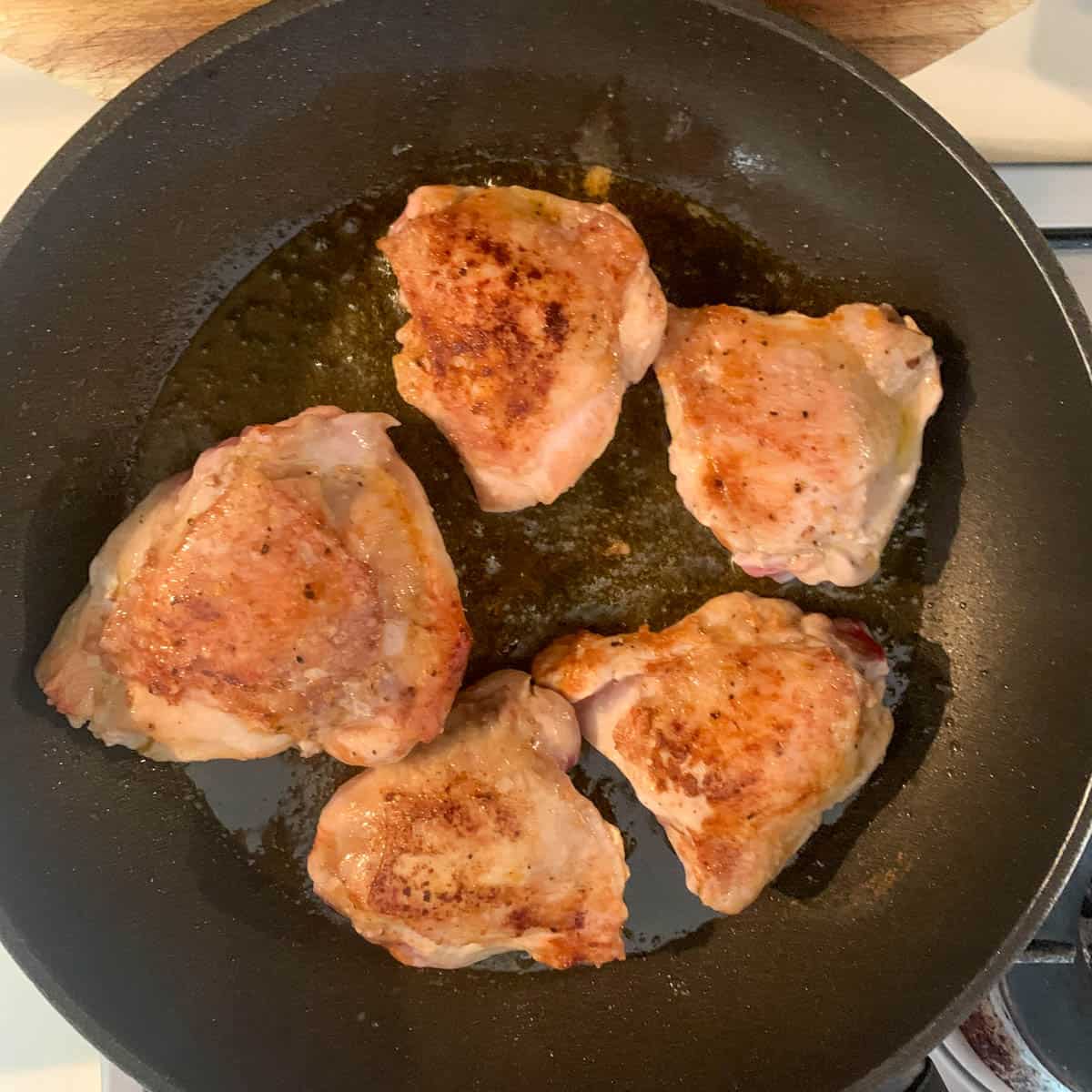 5 chicken golden chicken thighs in a frying skillet