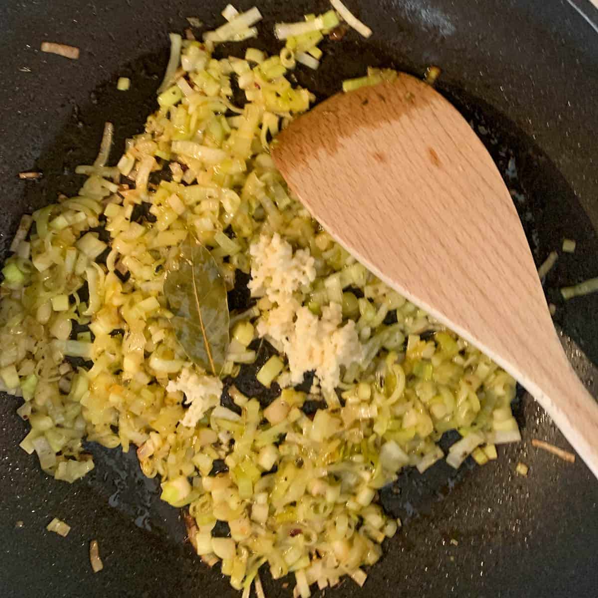 diced onions, minced garlic and spices in a frying pan