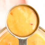 a spoon full with bang bang sauce.