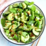 Asian smashed cucumber salad served in a white plate.