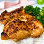 Golden baked chicken thigh on rice with broccoli.