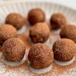 Cacao dusted bliss balls on a plate.