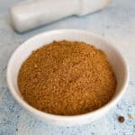 Freshly ground homemade pastrami seasoning in a small white bowl.